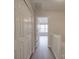 Bright hallway with white doors and wood-look flooring leading to a bedroom at 16967 Turning Stick Ct, Charlotte, NC 28213