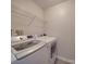 Laundry room with washer, dryer, and overhead shelving at 16967 Turning Stick Ct, Charlotte, NC 28213