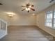 Spacious living room with laminate flooring, ceiling fan and access to back patio at 16967 Turning Stick Ct, Charlotte, NC 28213