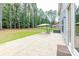 Spacious stamped concrete patio with umbrella, chair, and wooded backdrop at 2118 Lometa Rd, York, SC 29745