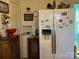 White refrigerator, wooden cabinet, and charming kitchen accessories at 24989 Nc Hwy 24/27 Hwy, Albemarle, NC 28001