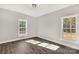 Well-lit bedroom with wood-look floors and two windows at 3290 Mt Prospect Rd, Chester, SC 29706