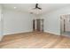 Light-filled bedroom with hardwood floors, ceiling fan, and access to bathroom at 419 Sylvania Ave, Charlotte, NC 28206