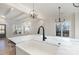 Sleek kitchen with a marble countertop, farmhouse sink, and black faucet at 419 Sylvania Ave, Charlotte, NC 28206