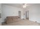 Spacious living room with neutral carpeting and ceiling fan at 504 Mclean Ave, Belmont, NC 28012