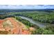 Aerial view of community with lake and wooded areas at 5365 Mint Harbor Way # 0300, Charlotte, NC 28269