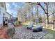 Brick paved patio with grilling station and wooded backyard at 7219 Fortrose Ln, Charlotte, NC 28277