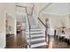 Elegant staircase with dark wood railings and white risers at 7219 Fortrose Ln, Charlotte, NC 28277