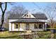 Charming white farmhouse with a covered porch and landscaped walkway at 1024 8Th St, Statesville, NC 28677