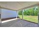 Covered patio with concrete flooring and wooded backyard view at 1030 Lake Como Dr, Monroe, NC 28110