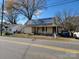 House visible from the road, with people near at 1102 N Hayne St, Monroe, NC 28112