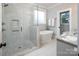 Spa-like bathroom with a large walk-in shower, soaking tub, and marble tile at 1814 Berryhill Rd, Charlotte, NC 28208