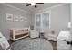 Charming Bedroom with crib, glider, and plenty of natural light at 1814 Berryhill Rd, Charlotte, NC 28208