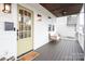 Inviting front porch with light yellow door and bench at 1814 Berryhill Rd, Charlotte, NC 28208