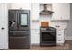 Stainless steel appliances and white cabinetry in kitchen at 1814 Berryhill Rd, Charlotte, NC 28208