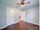 Spacious bedroom with wood floors and ceiling fan; access to another room at 356 Cooper Farm Rd, Statesville, NC 28625