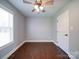 Well-lit bedroom featuring wood floors, a window with blinds, and a ceiling fan at 356 Cooper Farm Rd, Statesville, NC 28625