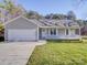 Newly constructed home with a gray exterior, white garage door, and a covered porch at 356 Cooper Farm Rd, Statesville, NC 28625