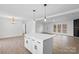 White kitchen island with a quartz countertop and pendant lighting at 44356 Harper Hearne Rd, New London, NC 28127