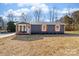 Newly built home with gray siding, a covered porch, and a landscaped yard at 505 Cedar Grove Dr, Gastonia, NC 28056