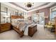 Main bedroom with a large bed, plenty of natural light, and an accent wall at 10118 Passau Path Dr, Huntersville, NC 28078