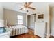 Bright bedroom with hardwood floors, ceiling fan, and built-in shelving at 110 1/2 Shamrock Ct, Fort Mill, SC 29715