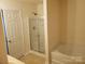 Bathroom with shower, bathtub and door to bedroom at 13926 Lawrence Farm Ln # L49, Charlotte, NC 28278