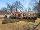 Brick ranch house with red accents and a well-maintained lawn at 2427 Sandlewood Dr, Gastonia, NC 28054