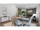 Open concept dining room with glass table and seating for six at 5145 Fireweed Ct, Dallas, NC 28034