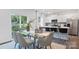 Dining area with glass table, gray chairs, and kitchen view at 5145 Fireweed Ct, Dallas, NC 28034