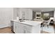 Modern kitchen with white cabinets, quartz countertops, and island at 5145 Fireweed Ct, Dallas, NC 28034