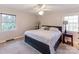 Spacious bedroom with a king-size bed, ceiling fan, and ample natural light at 7527 Gayle Ave, Charlotte, NC 28212