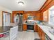 Bright kitchen with wood cabinets, stainless steel appliances, and a breakfast nook at 7527 Gayle Ave, Charlotte, NC 28212