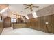 Bonus room with wood paneling, window, and loft area at 926 Bridlepath Ln, Charlotte, NC 28211