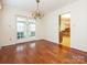 Bright dining room with hardwood floors and access to a sunroom at 926 Bridlepath Ln, Charlotte, NC 28211