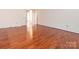 Hardwood floor living room with access to hallway at 926 Bridlepath Ln, Charlotte, NC 28211