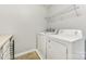 Bright laundry room, complete with washer, dryer, and ample shelving at 1003 Blue Range Rd, Indian Trail, NC 28079