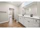 Double vanity bathroom with white cabinets and wood floors at 1430 Panther Rd, Lancaster, SC 29720