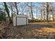 Detached storage shed in a wooded backyard at 2710 Julep Ln, Charlotte, NC 28273