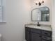 Updated bathroom with granite countertop and arched mirror at 640 Deerfield Dr, Mount Holly, NC 28120