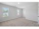 Well-lit bedroom with two windows and neutral carpeting at 8209 Stonemere Ln, Charlotte, NC 28215