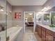 Luxurious bathroom with double vanity and large soaking tub at 10210 Linksland Dr, Huntersville, NC 28078