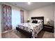 Cozy bedroom with patterned bedding and ample natural light at 1401 Nia Rd, Charlotte, NC 28215