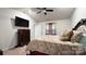 Bright bedroom featuring a king bed and mounted TV at 1401 Nia Rd, Charlotte, NC 28215