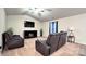 Relaxing living room with a fireplace and comfortable seating at 1401 Nia Rd, Charlotte, NC 28215