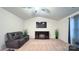 Living room featuring a mounted TV and electric fireplace at 1401 Nia Rd, Charlotte, NC 28215