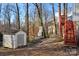 Backyard with shed, brick fireplace, and wooden deck at 1919 Crooked Creek Dr, Charlotte, NC 28214
