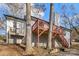 Elevated deck and stairs leading to backyard with trees at 1919 Crooked Creek Dr, Charlotte, NC 28214