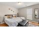 King-size bed, stylish decor, and large window in bedroom at 1919 Crooked Creek Dr, Charlotte, NC 28214