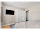 Bedroom with large closet and wall-mounted TV at 1919 Crooked Creek Dr, Charlotte, NC 28214